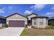 Charming one-story home featuring a two-car garage, neutral exterior, and well-maintained lawn at 8830 Fox Dr, Polk City, FL 33868