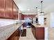 Well-lit kitchen boasts granite countertops, stainless steel appliances, and ample cabinet space at 8830 Fox Dr, Polk City, FL 33868