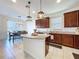 Charming kitchen showcases dark wood cabinetry, granite countertops, tile flooring and stainless appliances at 8830 Fox Dr, Polk City, FL 33868
