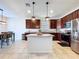Bright kitchen features granite countertops, stainless steel appliances, and a central island with pendant lighting at 8830 Fox Dr, Polk City, FL 33868