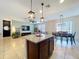 Open concept with granite island, dining area, and comfortable living space at 8830 Fox Dr, Polk City, FL 33868