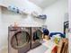 Laundry room with updated front loading washer and dryer at 8830 Fox Dr, Polk City, FL 33868
