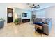 Comfortable living room with a modern ceiling fan, large TV, and cozy furnishings at 8830 Fox Dr, Polk City, FL 33868