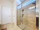 Glass enclosed shower with tiled surround and built in shelving at 8830 Fox Dr, Polk City, FL 33868