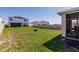 Spacious backyard featuring healthy green grass, a privacy fence, and a covered patio at 1123 Sugarwood St, Davenport, FL 33837