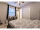 This cozy bedroom features a ceiling fan, a pair of dressers, a closet, and a comfortable bed at 1123 Sugarwood St, Davenport, FL 33837