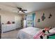 Inviting bedroom with a ceiling fan, bright decor, and ample natural light from the window at 1123 Sugarwood St, Davenport, FL 33837