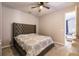 Comfortable bedroom featuring a plush bed with a tufted headboard and neutral décor at 1123 Sugarwood St, Davenport, FL 33837