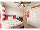 A comfy bedroom with ceiling fan, large closet, and neutral color scheme at 1123 Sugarwood St, Davenport, FL 33837