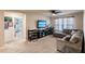 This spacious bonus room features a large sectional sofa and lots of natural light at 1123 Sugarwood St, Davenport, FL 33837