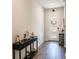 Elegant entryway with dark wood flooring, a console table with decor, and a view of the front door at 1123 Sugarwood St, Davenport, FL 33837