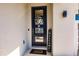 Inviting front door with glass panels, a decorative wreath, 'Welcome' sign, and modern exterior lighting at 1123 Sugarwood St, Davenport, FL 33837