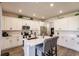 Bright open kitchen with an island, stainless steel appliances, and ample cabinet space at 1123 Sugarwood St, Davenport, FL 33837