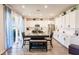 Bright eat-in kitchen boasts white cabinets, stainless steel appliances, and an abundance of natural light at 1123 Sugarwood St, Davenport, FL 33837