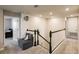 This upper landing area includes carpeted floors, neutral walls, and a comfortable seat at 1123 Sugarwood St, Davenport, FL 33837