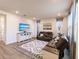 Bright living room features leather sofas, a geometric rug, neutral walls, and ample natural light at 1123 Sugarwood St, Davenport, FL 33837