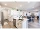 Open concept living room showcasing the stainless steel appliances and access to the living areas at 1123 Sugarwood St, Davenport, FL 33837