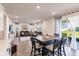 Open concept eat-in kitchen and living room featuring an entertainment center and leather sofa at 1123 Sugarwood St, Davenport, FL 33837
