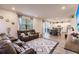 Open-concept living room with recliners, a graphic rug, and a view into the dining area and kitchen at 1123 Sugarwood St, Davenport, FL 33837