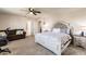 Cozy bedroom with a ceiling fan, seating area, and ample natural light at 1123 Sugarwood St, Davenport, FL 33837