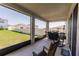 Screened patio with chairs, table, and serene backyard view at 1123 Sugarwood St, Davenport, FL 33837