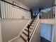 Carpeted staircase with white railings, leading to the second floor of the home at 1123 Sugarwood St, Davenport, FL 33837