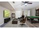 Finished basement with a TV, pool table, modern chairs, and neutral decor for entertaining at 5926 N Fork Ct, Lakeland, FL 33809