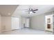 Unfinished basement with a ceiling fan, storage closet, door, and access to the basement bathroom at 5926 N Fork Ct, Lakeland, FL 33809