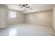 Spacious basement area featuring a ceiling fan, window, and neutral paint, ready to be customized at 5926 N Fork Ct, Lakeland, FL 33809