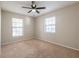 Comfortable bedroom featuring neutral carpet, ceiling fan, and natural light at 5926 N Fork Ct, Lakeland, FL 33809