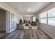 Staged living room with wood-look flooring, furniture, and decor at 5926 N Fork Ct, Lakeland, FL 33809