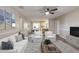 Bright living room with modern furniture, decor, and a ceiling fan that seamlessly connects to the dining area and kitchen at 5926 N Fork Ct, Lakeland, FL 33809