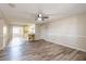 Open living room with wood flooring, adjacent to the dining area and kitchen, offers a flexible living space at 5926 N Fork Ct, Lakeland, FL 33809
