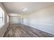 Large living room with updated wood-look floors, neutral paint, and lots of light at 5926 N Fork Ct, Lakeland, FL 33809