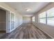 Spacious living room featuring wood-look flooring, natural light, and neutral paint at 5926 N Fork Ct, Lakeland, FL 33809