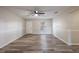 Spacious living room with wood flooring, neutral paint, ceiling fan, and a window letting in lots of natural light at 5926 N Fork Ct, Lakeland, FL 33809