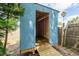 Shed featuring unfinished interior, wood framing, metal roof, and exterior ramp access at 5926 N Fork Ct, Lakeland, FL 33809