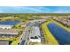 An aerial view showcases the townhome community bordering two lakes with lush landscaping and meticulous street design at 7614 Oak Spring Ln, Davenport, FL 33837