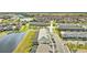 An aerial view features the townhome near a lake with lush surroundings and serene lake views at 7614 Oak Spring Ln, Davenport, FL 33837