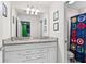 Bathroom with double sink vanity, granite counters, and themed shower curtain at 7614 Oak Spring Ln, Davenport, FL 33837