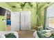 Charming green bedroom with a hanging swing, nature-themed decor, and easy access to an adjacent superhero-themed room at 7614 Oak Spring Ln, Davenport, FL 33837