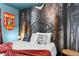 Bedroom featuring an ornate headboard, dark forest mural, and Harry Potter themed decorations at 7614 Oak Spring Ln, Davenport, FL 33837
