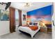 Bedroom with sunset mural, unique lighting, and Star Wars decor accents at 7614 Oak Spring Ln, Davenport, FL 33837