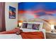 Bedroom with sunset mural, unique lighting, and Star Wars decor accents at 7614 Oak Spring Ln, Davenport, FL 33837