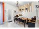 Bright dining area with unique light fixture and wooden decor, and direct access to the backyard at 7614 Oak Spring Ln, Davenport, FL 33837