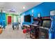 Large game room with foosball, arcade games, and vibrant color scheme at 7614 Oak Spring Ln, Davenport, FL 33837