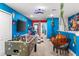 Fun game room with vibrant blue walls and game-themed decor, seating, and foosball at 7614 Oak Spring Ln, Davenport, FL 33837