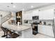 Modern kitchen features granite countertops, white cabinets, and stainless steel appliances at 7614 Oak Spring Ln, Davenport, FL 33837