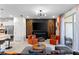Cozy living room boasts a feature wall, fireplace, and modern lighting, perfect for entertaining at 7614 Oak Spring Ln, Davenport, FL 33837