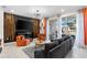 Comfortable living room with a TV, outdoor patio access and stylish decor at 7614 Oak Spring Ln, Davenport, FL 33837